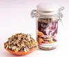 A jar of incense mixture and a small pile of the mixture in a terracotta dish, set against a white background. Produktbild-Vorschau
