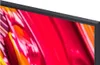 A close-up view of the corner of a television screen displaying a vibrant, abstract image with red, orange, and yellow colors, framed by a black bezel. Voir les images du produit