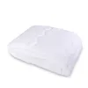 A folded white comforter and pillow set on a white background. Náhled obrázku produktu