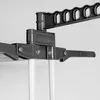 A close-up view of a gray plastic drying rack mechanism with white poles attached. Produktbild-Vorschau
