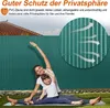 A woman and child are doing yoga in front of a green PVC fence, with text overlays describing the product's features. Produktbild-Vorschau