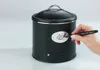 A hand is using a marker to draw on a black storage container with a garlic illustration. Produktbild-Vorschau