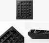 A collage of three images showing a black mechanical numpad base with a rotary knob, from different angles. Produktbild-Vorschau