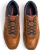 A top-down view of a pair of brown leather and suede sneakers with blue laces. Produktbild-Vorschau