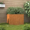 A Corten steel planter filled with a green shrub, placed on a lawn in front of a wooden fence. Náhled obrázku produktu