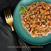 A close-up view of pet food served on a plate, with a fork and napkin. Produktbild-Vorschau