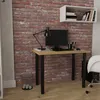 A desk with a computer and lamp in front of a brick wall. Produktbild-Vorschau