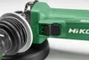 A close-up view of a green electric angle grinder, focusing on the switch and part of the handle. Anteprima dell’immagine prodotto