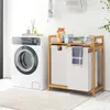 A laundry room scene with a washing machine, a bamboo laundry sorter with two compartments, and laundry supplies. Anteprima dell’immagine prodotto