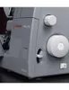 A close-up of a gray sewing machine with white dials and a switch. Produktbild-Vorschau