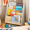 Nahaufnahme des SoBuy Regals KMB106-HG mit drei Fächern, gefüllt mit Kinderbüchern, im Kontext eines hellen Kinderzimmer Náhľad obrázku produktu