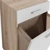 A close-up view of a wooden and white cabinet with a drawer pulled out, revealing a brown fabric liner. Produktbild-Vorschau