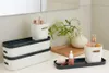 Bathroom counter with storage boxes and toiletries. Produktbild-Vorschau