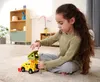 A young girl is playing with a toy car on the floor. Produktbild-Vorschau