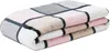 A folded blanket with a plaid pattern. Produktbild-Vorschau