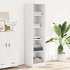 A white tall narrow cabinet with shelves filled with folded clothes and a basket, next to a white cabinet with drawers and doors, in a room with a large potted plant. Voir les images du produit