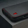 Close-up of a black leather phone case with red stitching and a red bull logo. Produktbild-Vorschau
