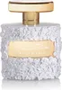A perfume bottle with a white floral design and a gold cap and label. Podgląd zdjęcia produktu