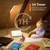 A young boy is drawing at a desk under a floor lamp in an attic room. Produktbild-Vorschau