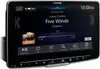 A close-up of an Alpine car stereo system displaying music playback information. Podgląd zdjęcia produktu