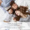 A family lying on a bed, smiling and looking up. Produktbild-Vorschau