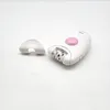 A white Braun Silk Epil 1 electric epilator with a pink button and a detached cap is placed on a white surface. Produktbild-Vorschau
