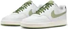 A pair of white Nike Court Vision Low sneakers with green accents. Produktbild-Vorschau