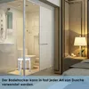 A modern bathroom with a shower stall and a bedroom with a nightstand and lamp. Produktbild-Vorschau