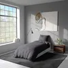 A bedroom scene with a bed, a large window, and artwork on the wall. Produktbild-Vorschau