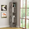 A corner bookshelf with books and decor next to a large window with greenery outside. Produktbild-Vorschau