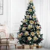 A decorated Christmas tree in a room with a fireplace and chair. Produktbild-Vorschau