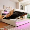 A modern bed with its storage compartment open, revealing stored items and illuminated by LED lights. Náhľad obrázku produktu