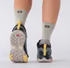 A close-up rear view of a person wearing Salomon hiking boots and socks. Produktbild-Vorschau