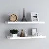 Two white floating shelves mounted on a light gray wall, displaying various decorative items. Voir les images du produit