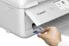 A hand inserts a memory card into a Canon printer. Podgląd zdjęcia produktu