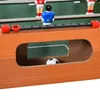 A close-up view of a foosball table, showing players and a soccer ball. Voir les images du produit