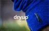 Close-up of a blue fabric cape with a logo and text on it. Produktbild-Vorschau