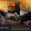 Two people are relaxing by an electric fireplace, with their feet up and wearing socks. There are two mugs on the floor in front of them. Produktbild-Vorschau