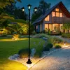 A garden scene at dusk with a house and a lamppost. Produktbild-Vorschau
