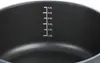 A close-up view of the inside of a black cooking pot with measurement markings. Anteprima dell’immagine prodotto