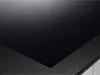 A close-up view of a black glass ceramic hob with a textured gray edge. Anteprima dell’immagine prodotto
