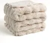 A stack of folded, plush blankets. Produktbild-Vorschau