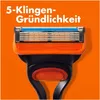 A close-up of a Gillette Fusion5 razor head against an orange background. Produktbild-Vorschau
