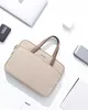 A beige laptop bag is displayed on a white background surrounded by various electronic accessories. Anteprima dell’immagine prodotto