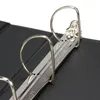 A close-up view of the metal rings and mechanism of a black binder. Produktbild-Vorschau