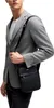 A man wearing a grey blazer and a white t-shirt, carrying a black messenger bag. Anteprima dell’immagine prodotto