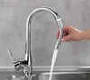 A hand is shown holding a flexible faucet hose with water running through it into a sink. Produktbild-Vorschau