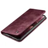 A burgundy flip case for a smartphone is shown from a diagonal angle, with the phone partially visible inside. Produktbild-Vorschau