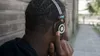 A person wearing headphones outdoors. Produktbild-Vorschau