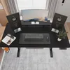 A top-down view of a black standing desk setup with a monitor, keyboard, mouse, and two awards. Náhľad obrázku produktu